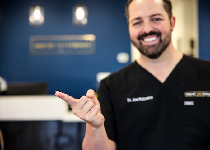 Dr holding Contact Lens