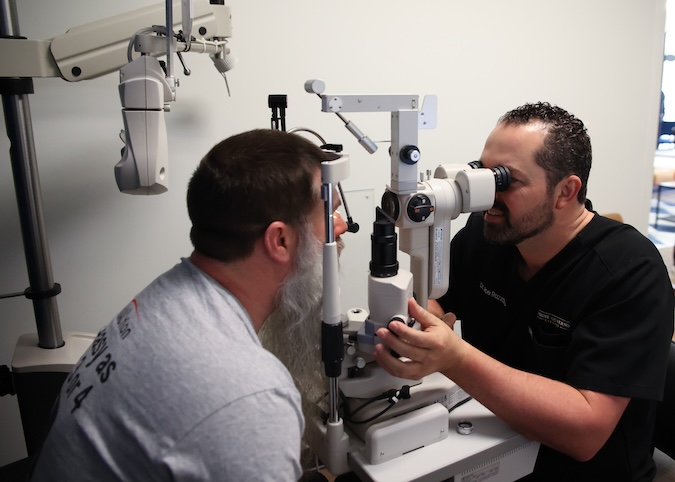 Dr Razzano conducting an Eye Exam